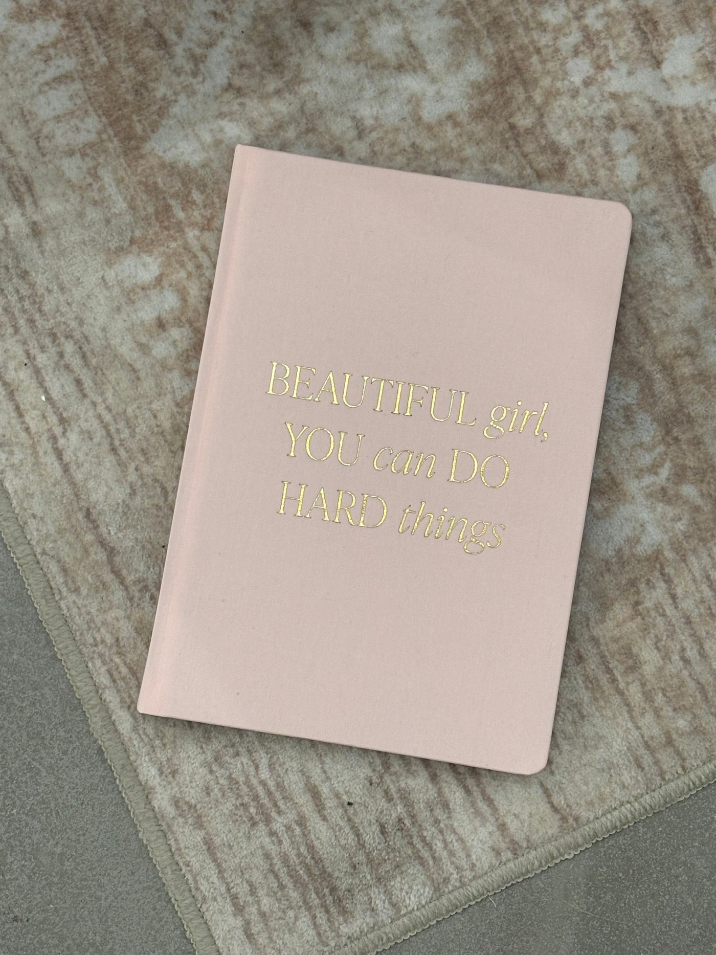 Pink notebook with gold text on a textured surface Beautiful Girl Fabric Journal