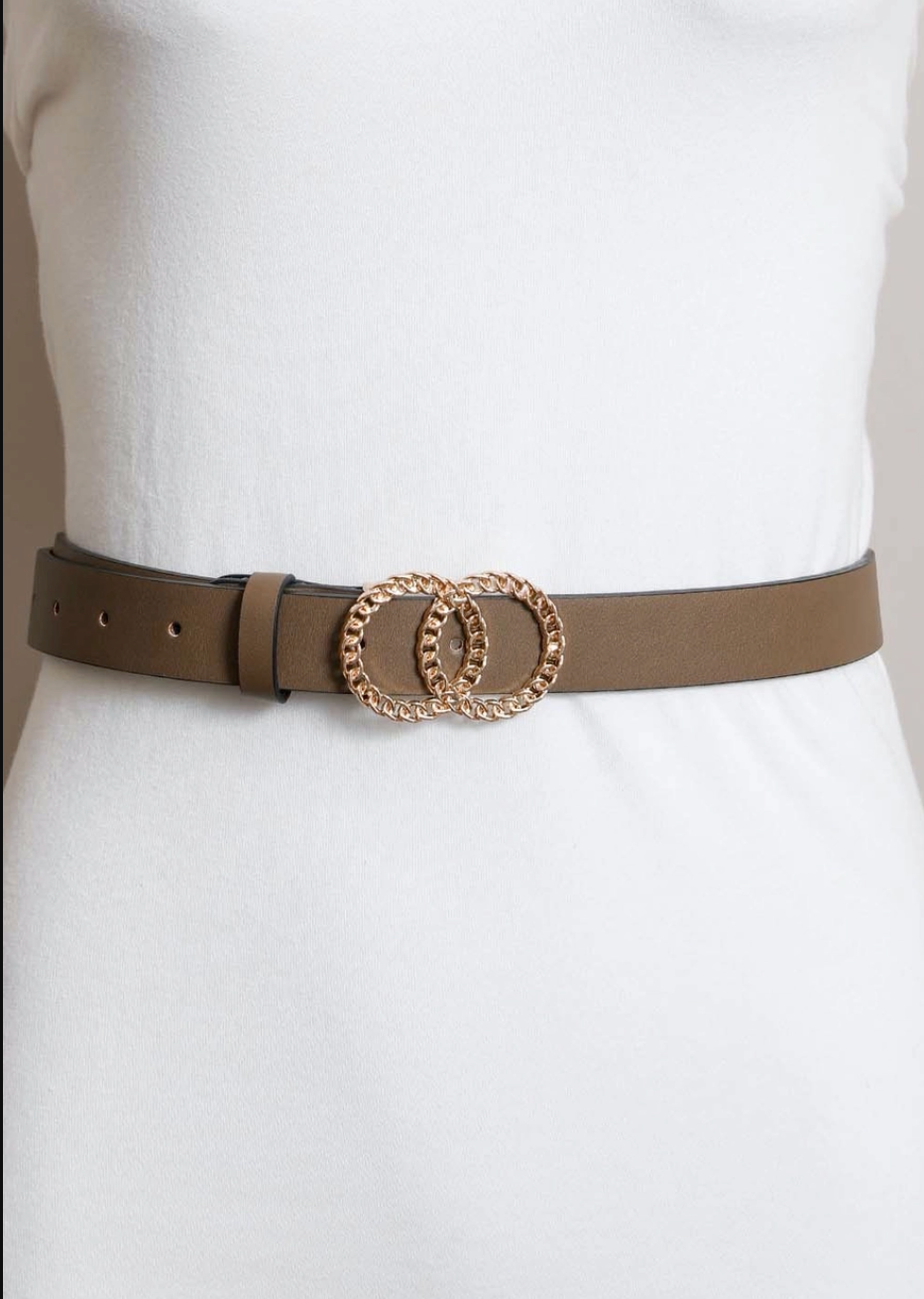 A slim brown leather belt with a double interlocking rope-textured gold-tone buckle, shown worn on a white dress form.